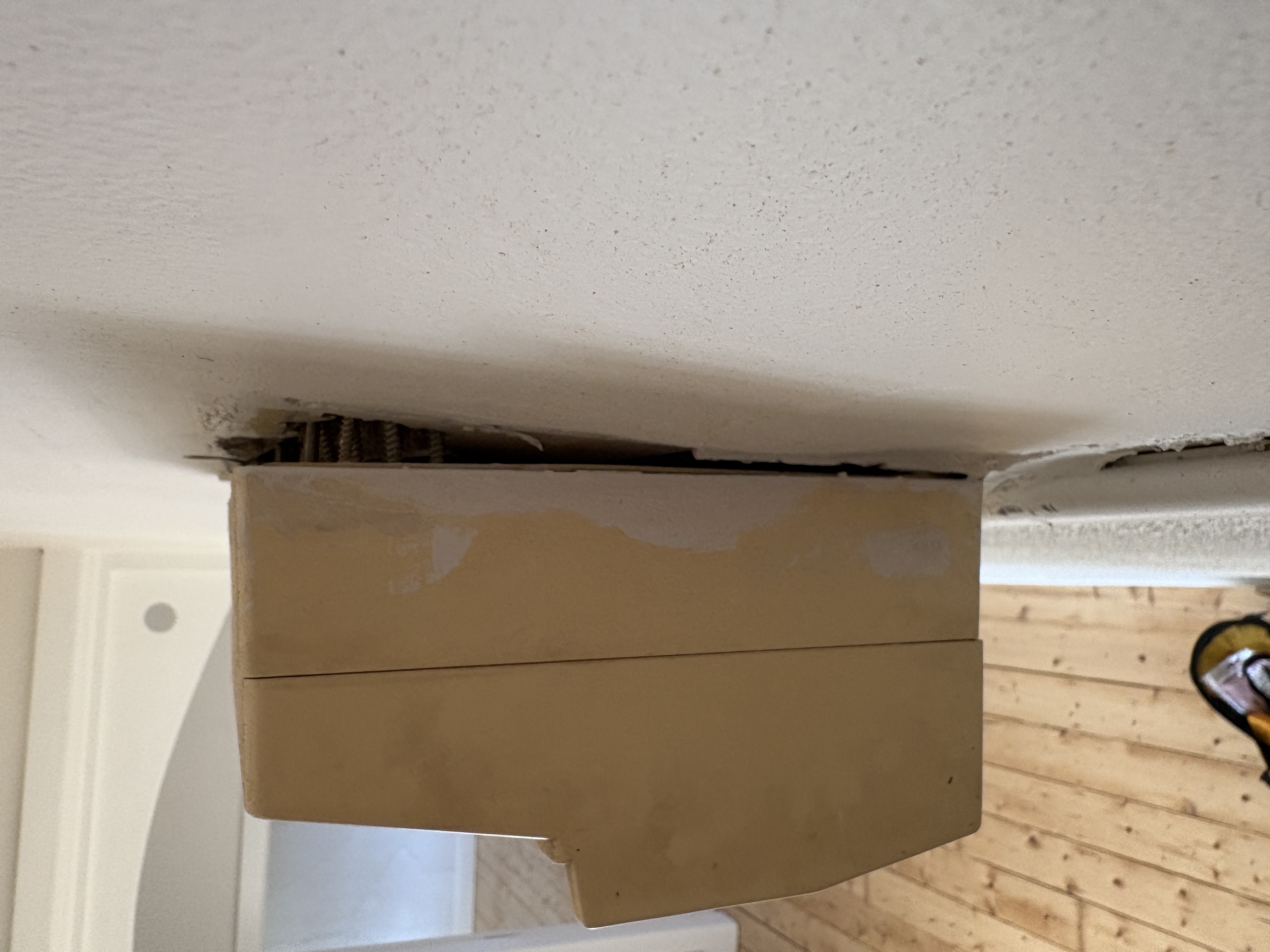 Switchboard found pulling away from wall during inspection — a significant defect requiring investigation